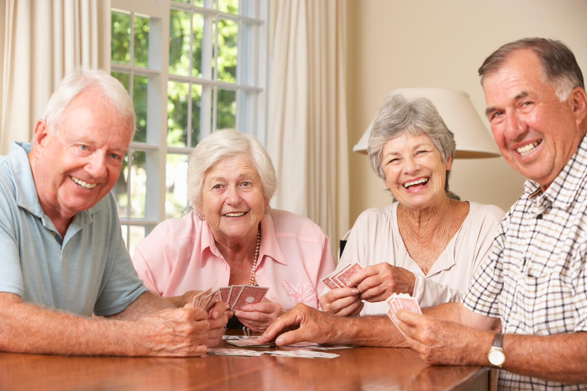 Senior Couples Enjoying Game Of Cards