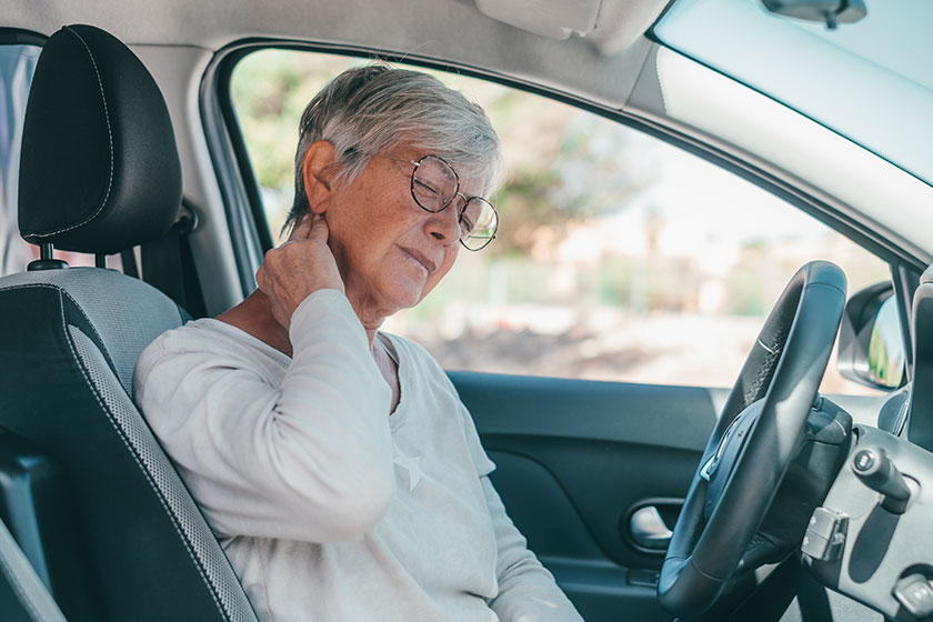 Rear view of old woman having neck pain
