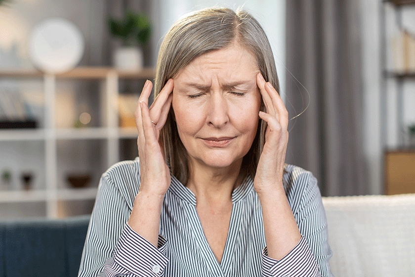 Frustrated senior lady suffering from strong sudden migraine