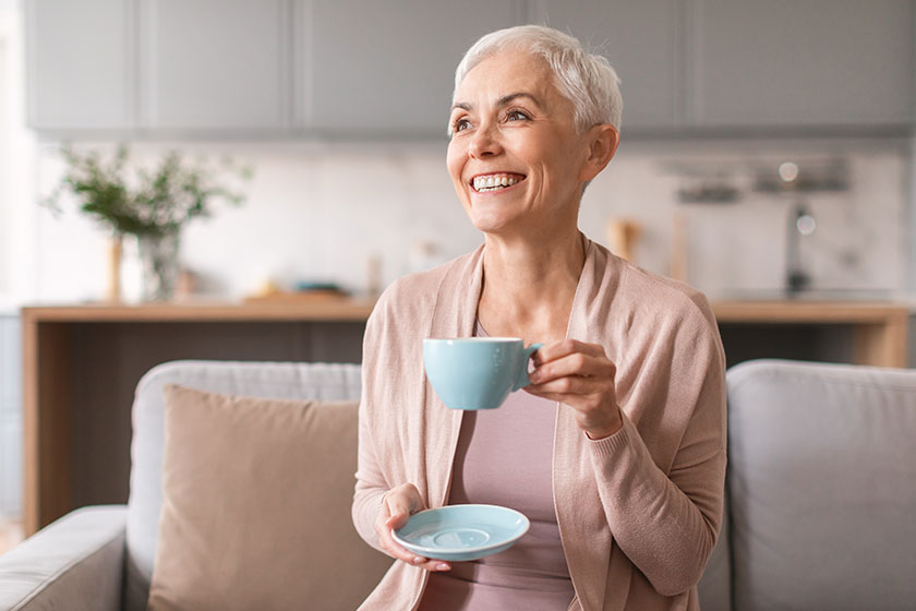 Attractive mature lady drinking fresh coffee or tea